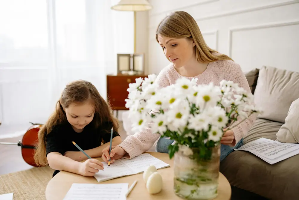 A parent guiding a child through schoolwork